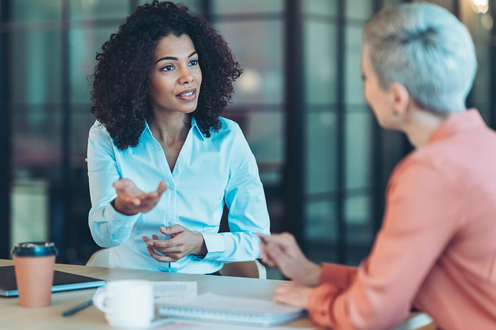 Two women in conversation in an office setting